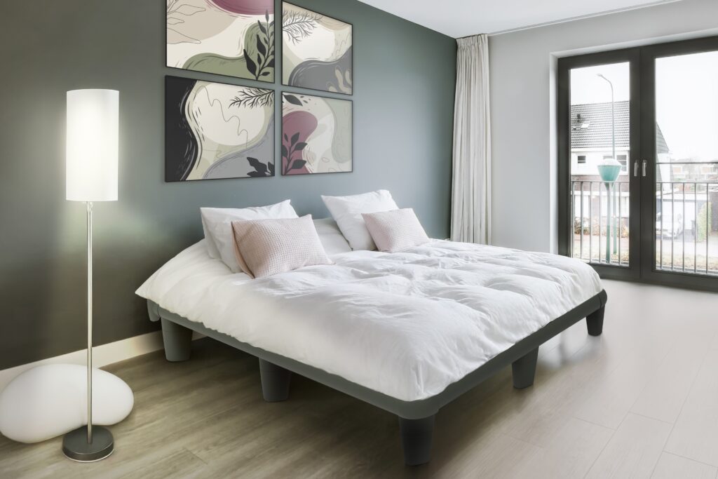 A modern bedroom featuring a stylish, minimalist platform bed.