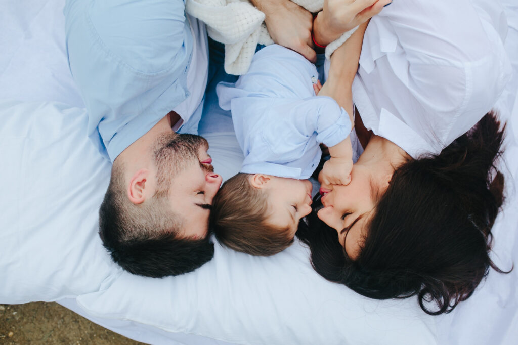 Parent co-sleeping with toddler peacefully on a heavy-duty bed for families with toddlers.