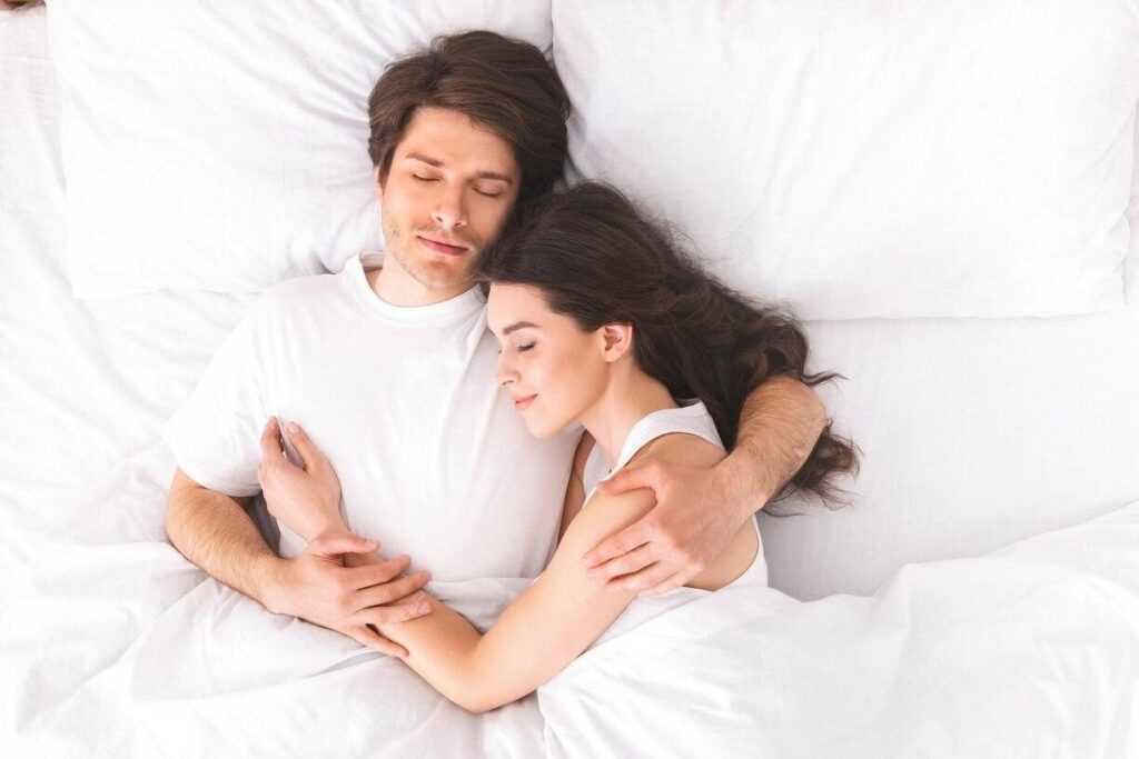  Couple sleeping peacefully together on a no squeak bed frame